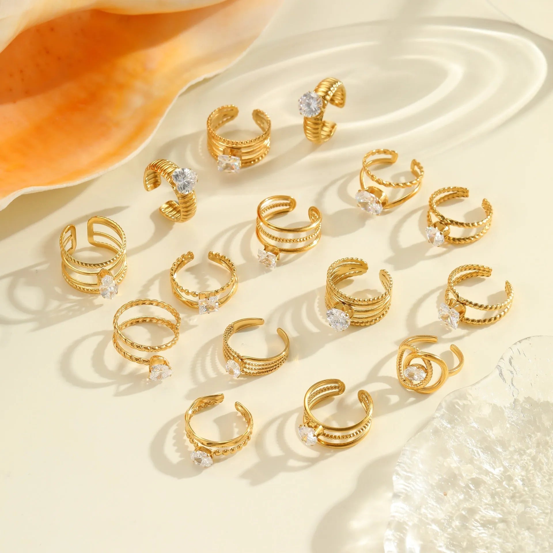 Gold electroplated stainless steel ring with geometric heart shape and inlaid zircon stones, open mouth adjustable design.
