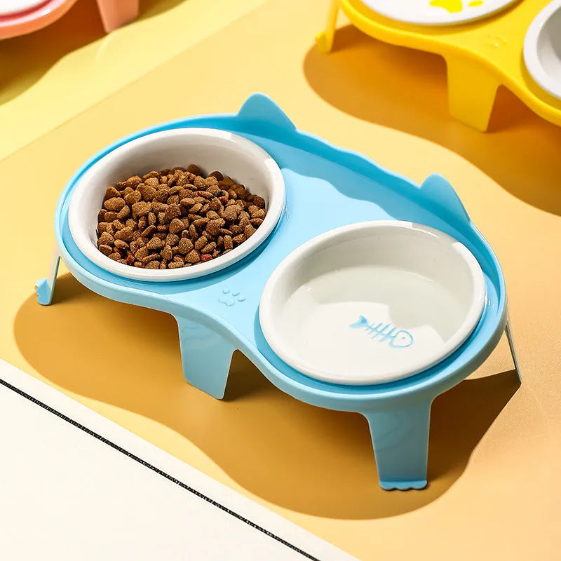 Blue ceramic cat food and water bowl set on a white elevated stand with storage hook