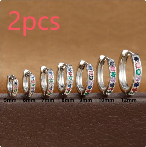 Set of three pairs of round zircon stud earrings showing gold colour, rose gold colour, and silver colour finishes.