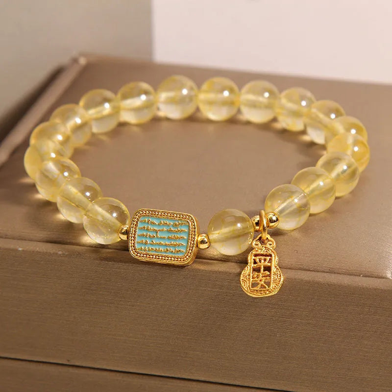 Women's yellow citrine crystal bracelet with rhinestone detailing on wrist