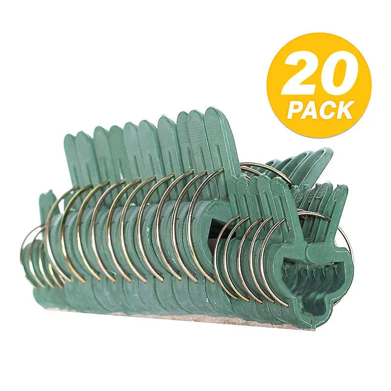 Green plastic plant fixing clips holding tomato vine to garden stake