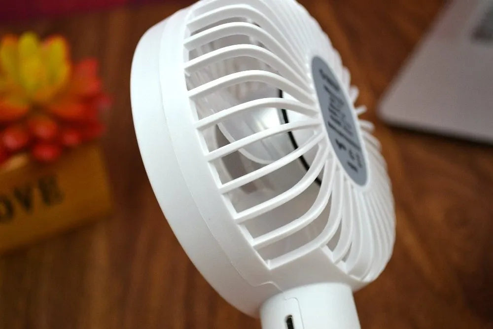White ORICO FH1 portable USB rechargeable desk fan with three speed buttons and a compact design.