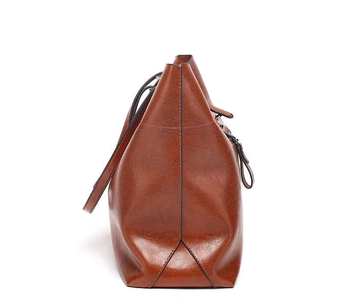 Brown waxed cowhide leather ladies crossbody handbag shown open, revealing internal organiser pockets.