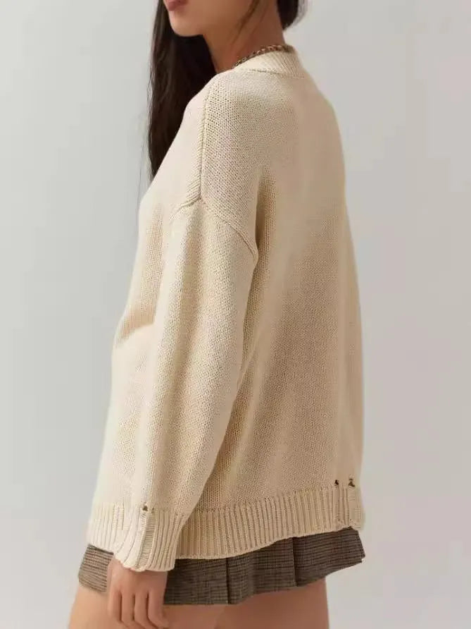 Milky white women's loose-fit pullover sweater with Jacquard knit texture on a hanger.
