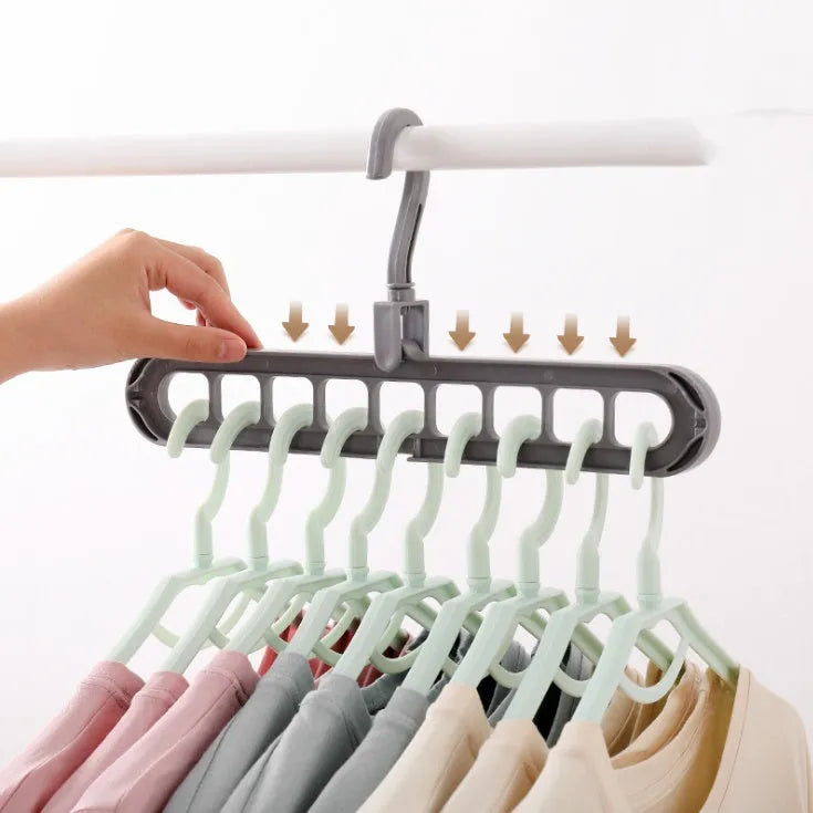 Plastic clothes hanger with rotating hook shown in pink, dimensions 33 cm long by 17 cm high