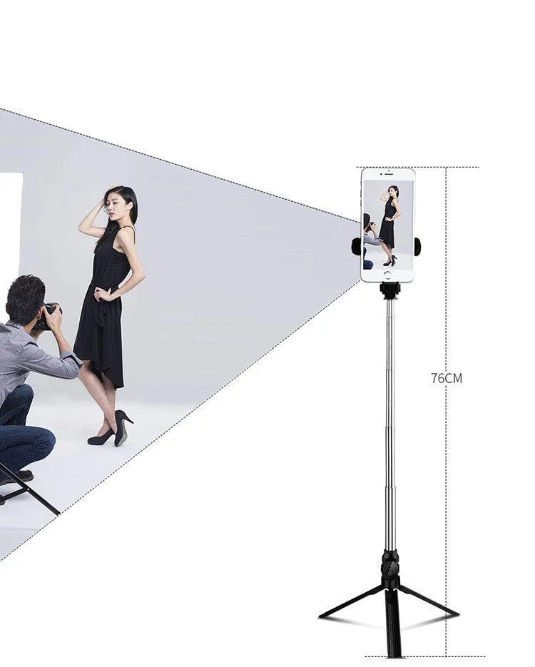 Apple-compatible black tripod selfie stand with Bluetooth remote and 360-degree rotating phone clip extended.