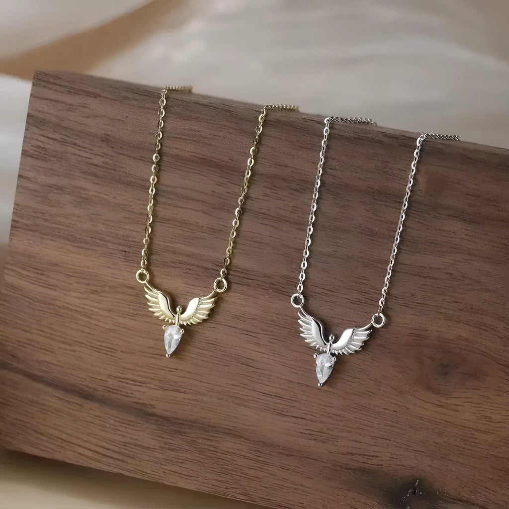 Women's eagle pendant silver necklace with O-ring chain on a grey background.