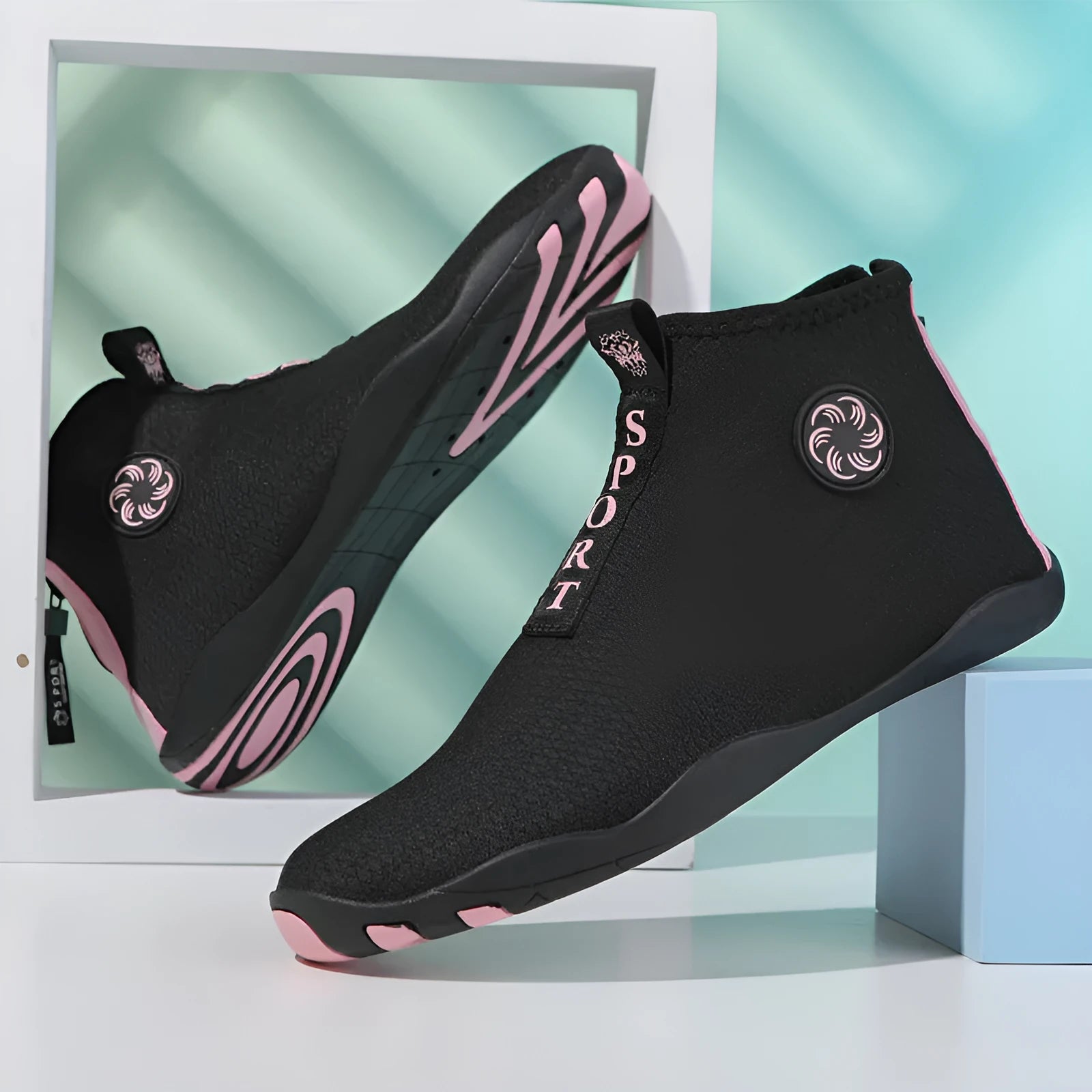 Casual mid-top outdoor beach shoes in black with coloured accents, showing mesh upper and rubber sole.