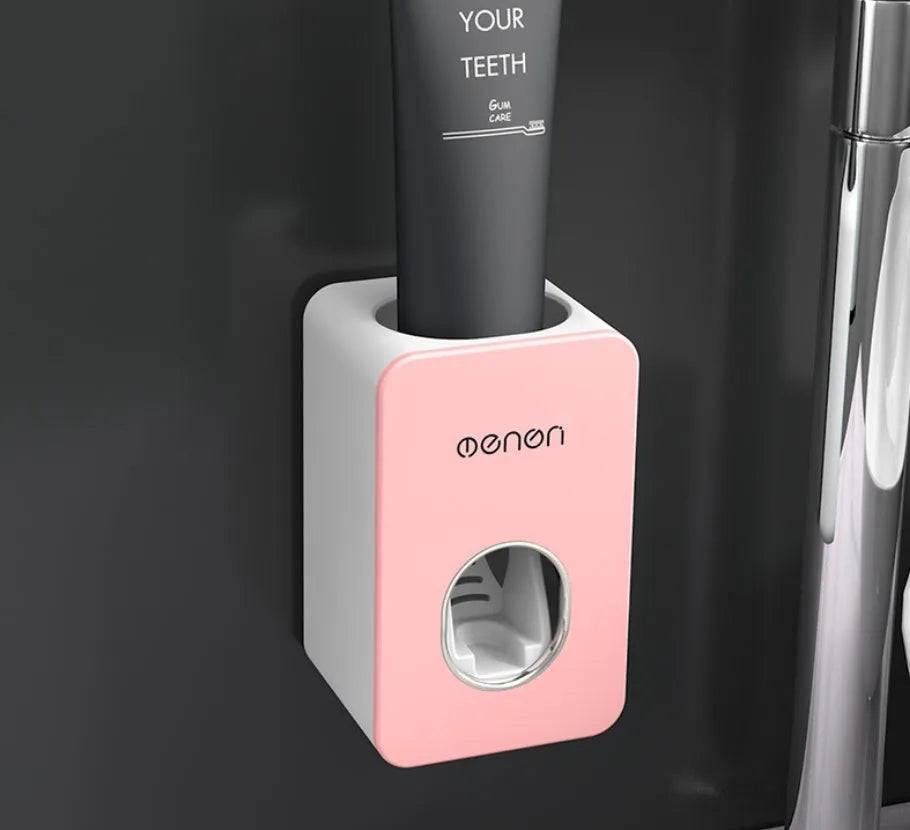 White and grey wall mounted automatic toothpaste dispenser with toothbrush rack, shown in grey, green and pink colour options.