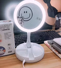 White acrylic LED vanity mirror with USB port and foldable storage compartments