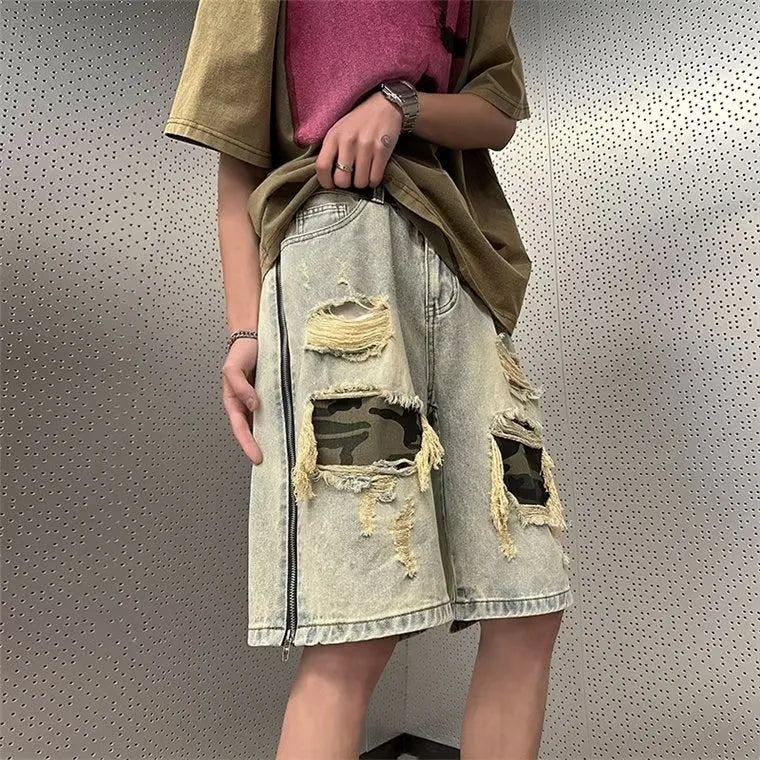 Men's yellow camouflage denim shorts with distressed rips and straight leg cut