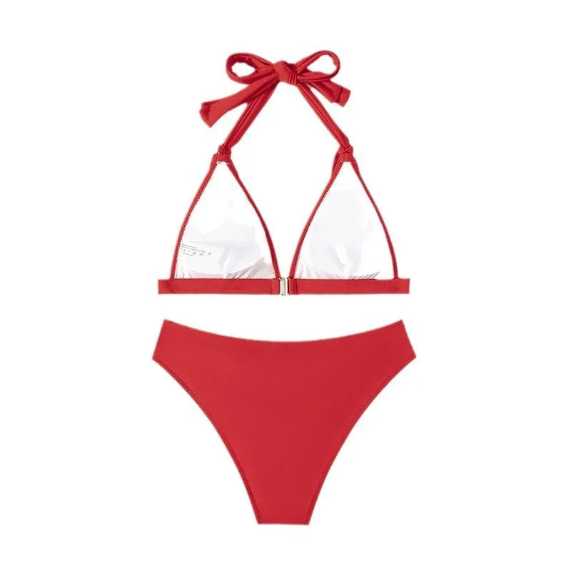 Red women's lace-up halterneck bikini with split shorts on mannequin