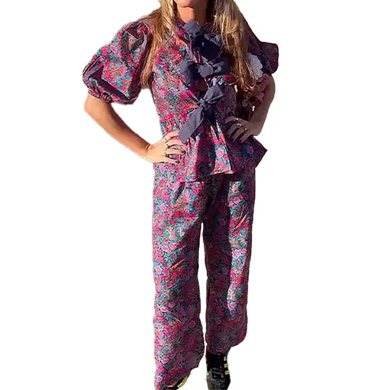 Floral print trousers suit with tie-neck top and puff sleeves, matching two-piece set