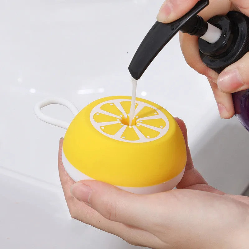 Yellow silicone pet bath brush with interchangeable heads for dog and cat grooming during washing