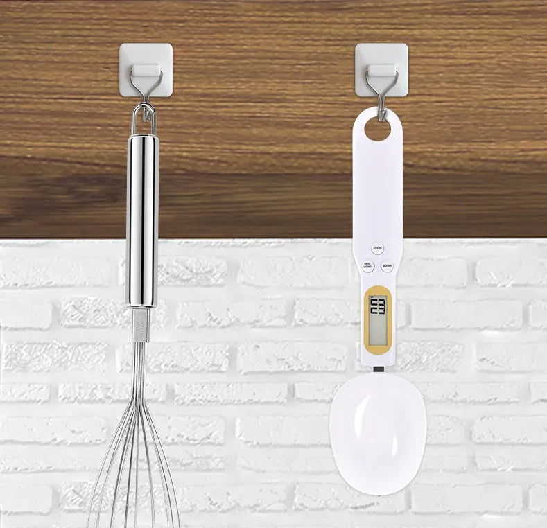 Black electronic measuring spoon scale showing digital display and spoon bowl for kitchen weighing