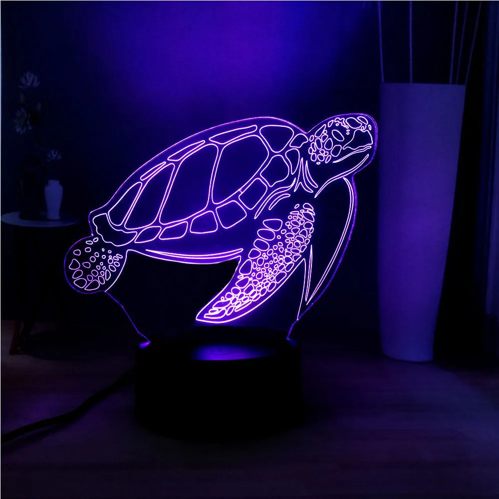 3D acrylic turtle-shaped LED night light with remote control on a table