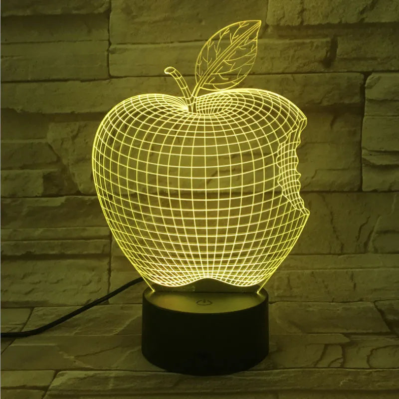 3D fruit-shaped colourful LED night light with touch control on a surface