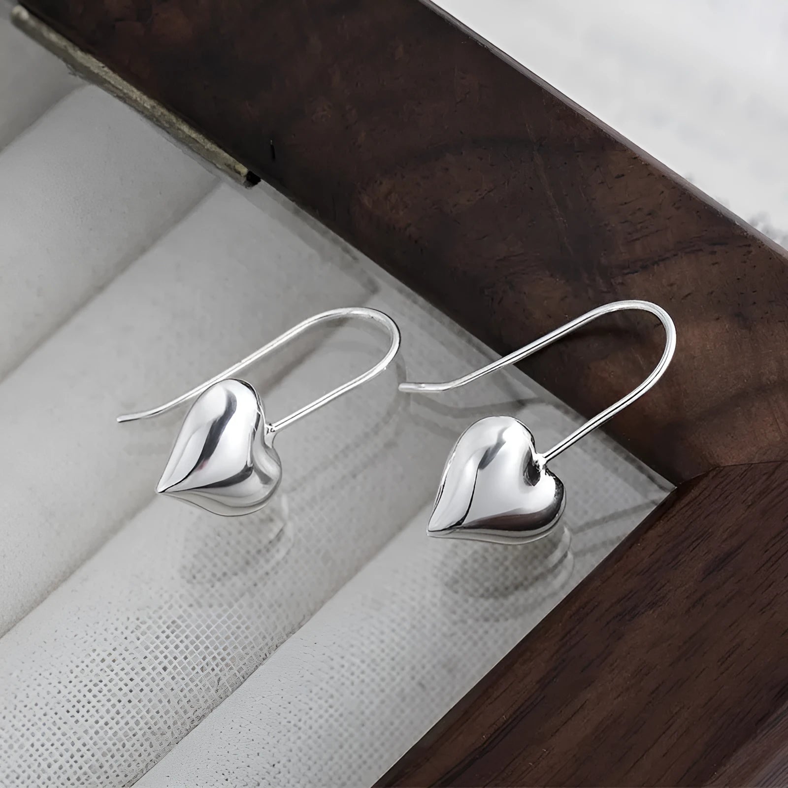 Three-dimensional copper heart earrings with glossy finish and Korean-style design
