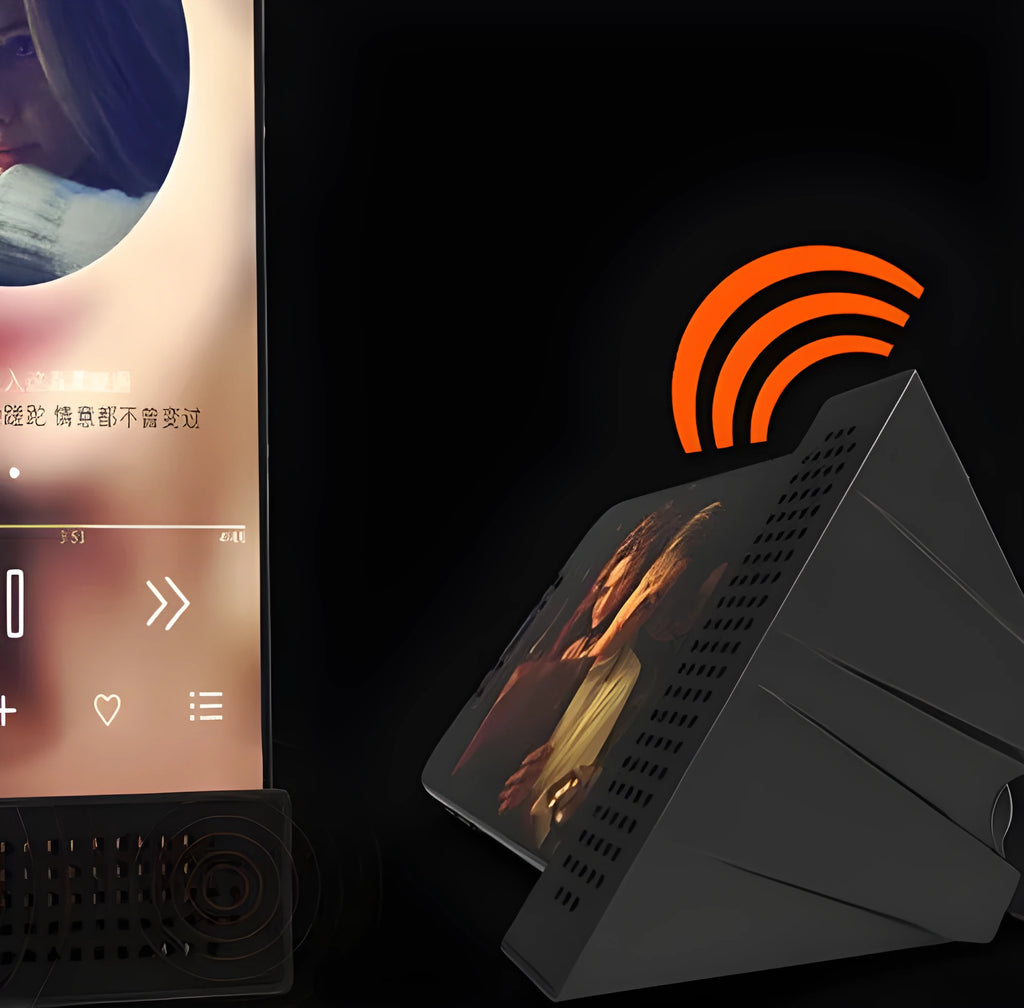Pink portable ABS mobile phone amplifier bracket holding a smartphone horizontally on a desk.