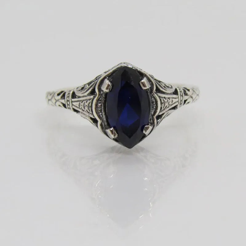 Silver women's geometric hollow ring in electroplated alloy on a plain background.