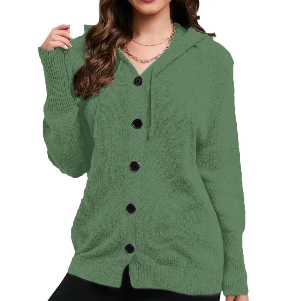 Woman wearing a loose-fit, thick cotton hooded cardigan sweater in a solid colour.