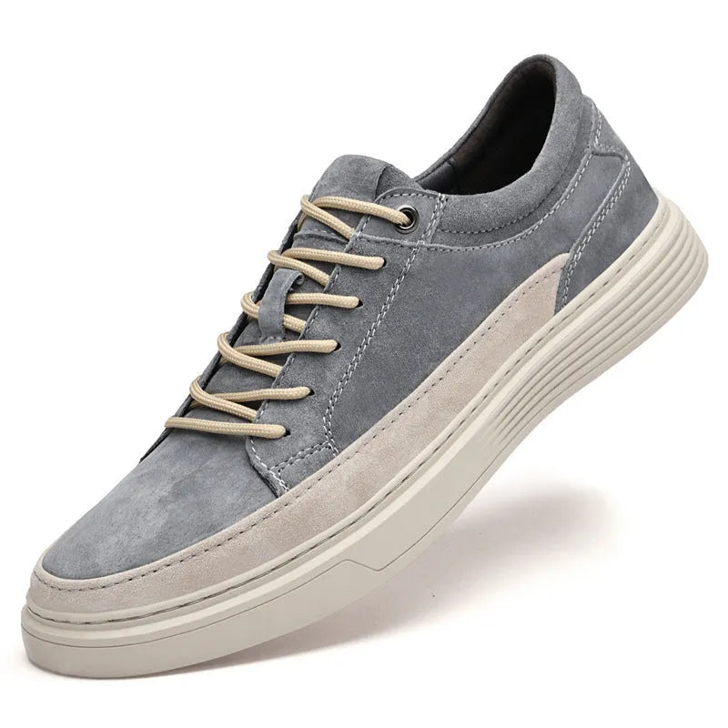 Grey and sand coloured low-top casual skate shoes with pigskin leather upper and rubber sole.