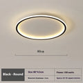 Modern minimalist black ceiling lamp with LED lights and dimming control on a bedroom ceiling.