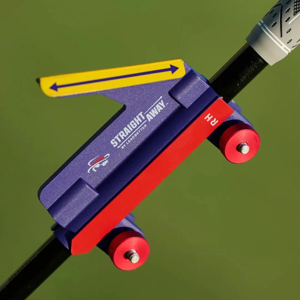 Plastic golf swing plane simulator training aid on a green surface.