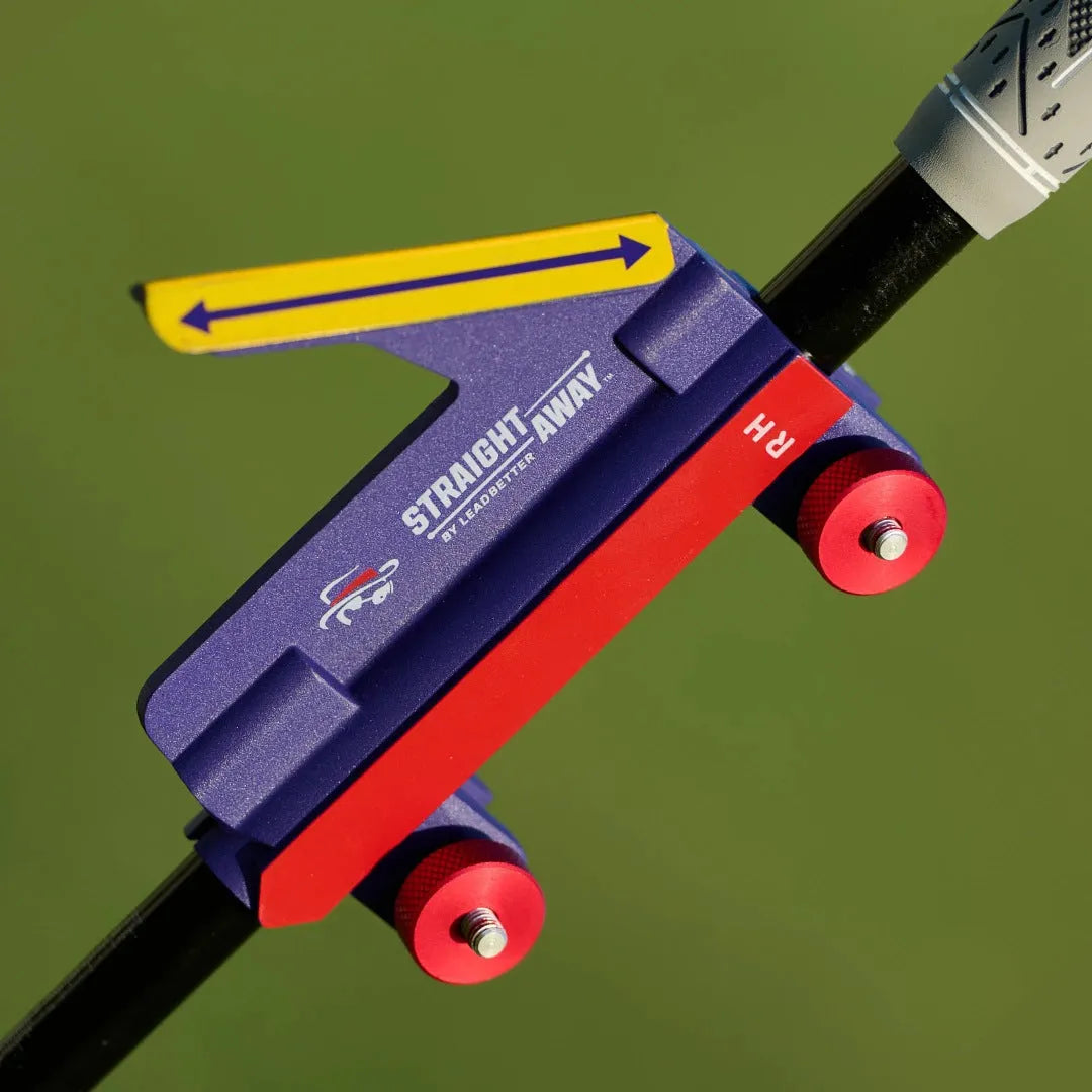 Plastic golf swing plane simulator training aid on a green surface.