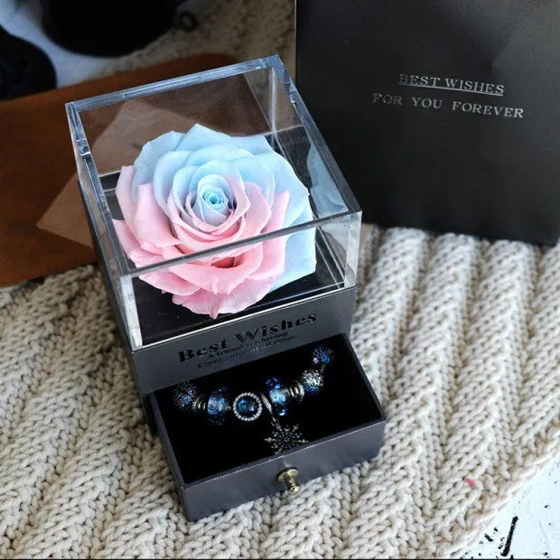 Glass eternal flower jewellery box with preserved roses and carnations inside measuring 8.5cm square