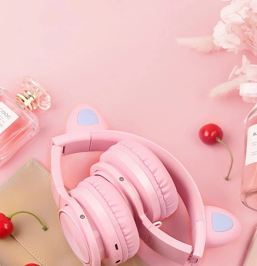 Pink and white wireless Bluetooth headset with over-ear design and 40mm speakers