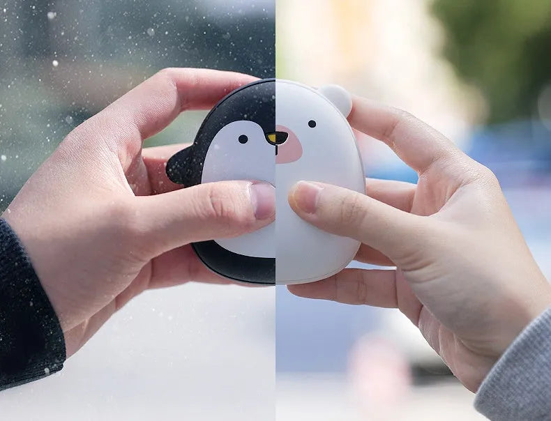 USB rechargeable electric hand warmer with penguin polar bear design showing front and back heating surfaces