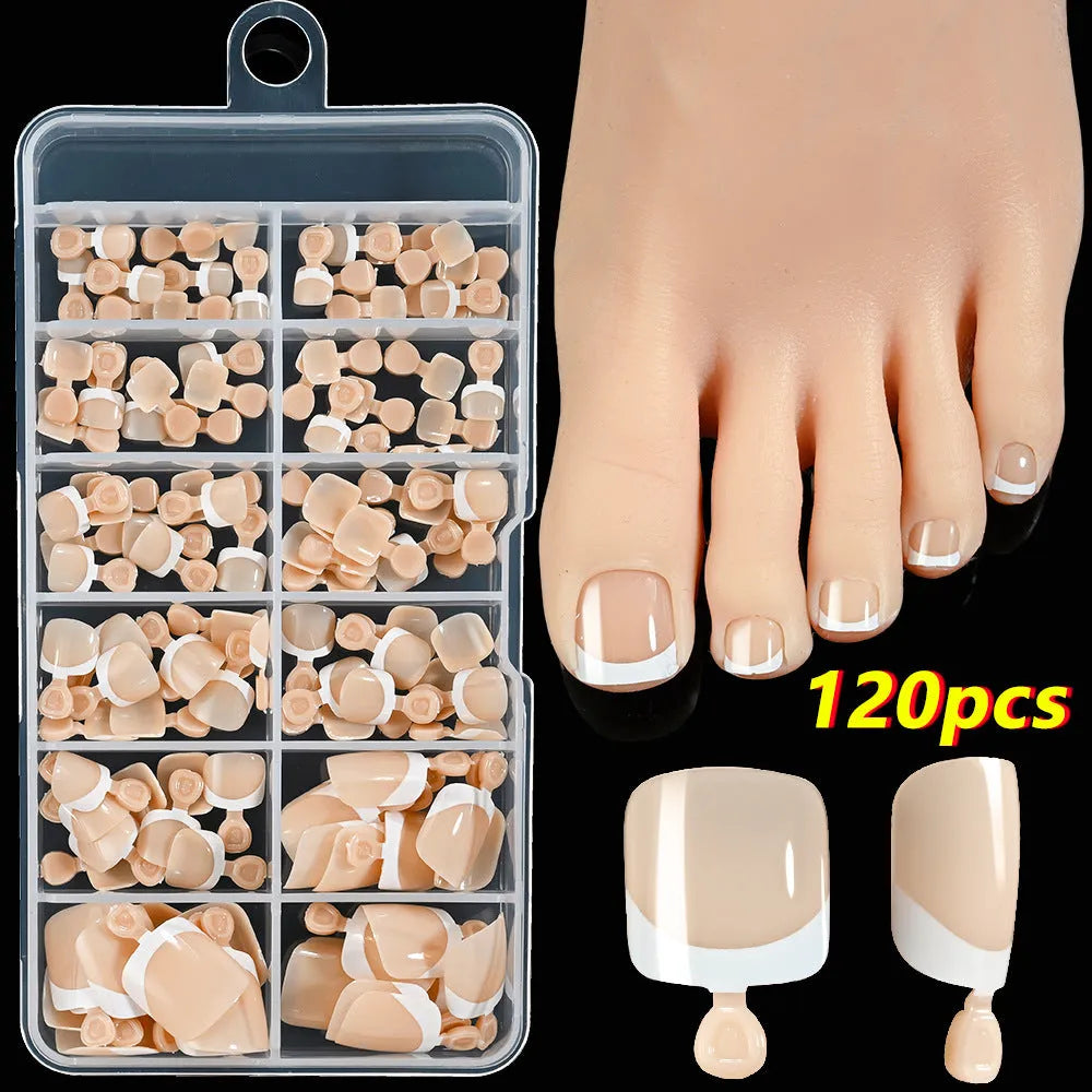 120 piece box of square short French style artificial toe nails with white tips on nude base.
