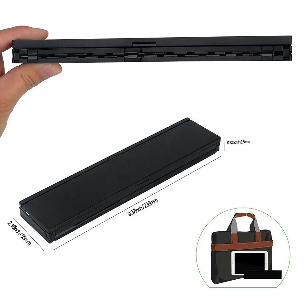 Black folding Bluetooth keyboard unfolded next to tablet showing ultra-thin design