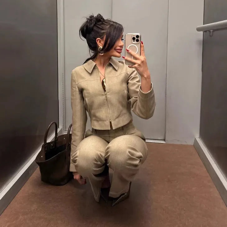 Women's light coloured herringbone pattern summer suit with jacket and straight-leg trousers, showing 3D pattern effect and embroidery details.