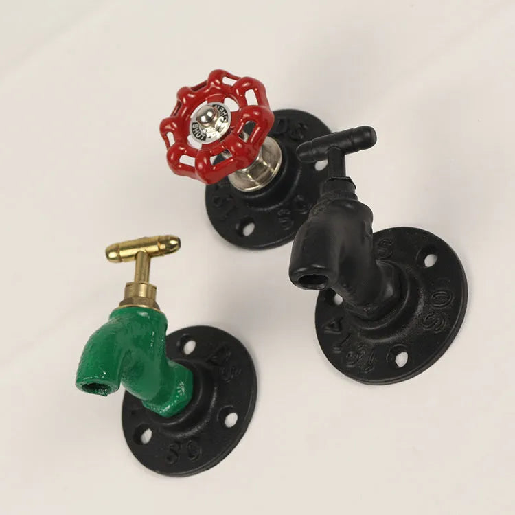 Metal water pipe style towel hook mounted on a wall in black, green, or red.