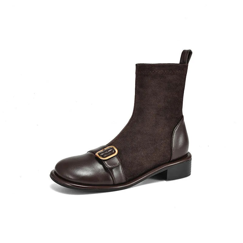 Women's black low heel Martin ankle boots with lace-up front and buckle stitch detail on a white background.