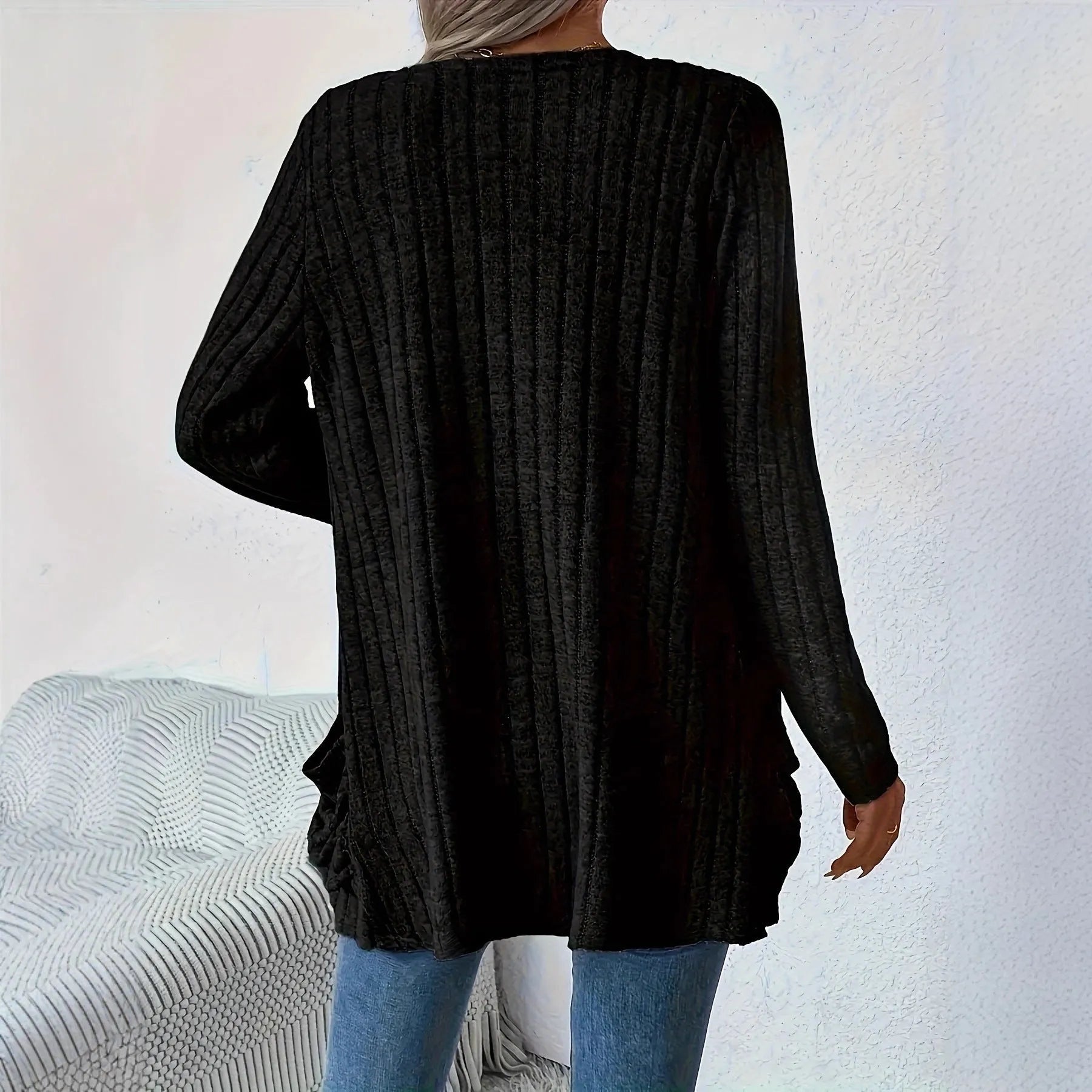 A solid colour long sleeve cardigan with pockets, shown in a loose fit on a model.