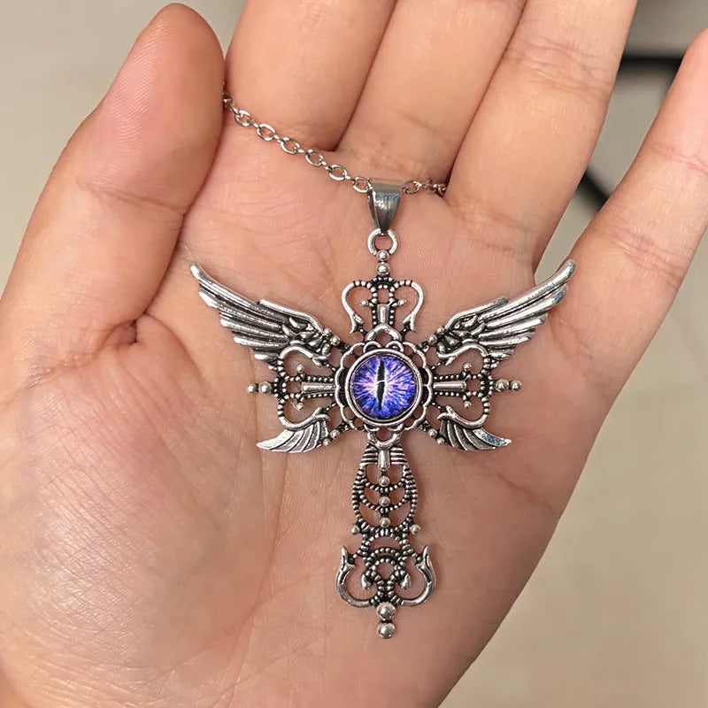 Geometric devil wings and cross alloy pendant necklace on a chain in blue colour.