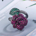 Gold-plated copper women's ring with geometric flower design and simulated red corundum in black gold colour.
