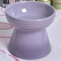 Black and white ceramic pet bowl with a high foot and anti-tumble chin design for dogs and cats.