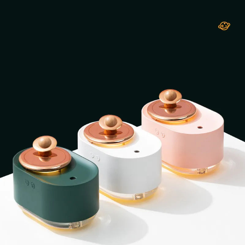 Green rotating planet USB humidifier with night light on a wooden desk