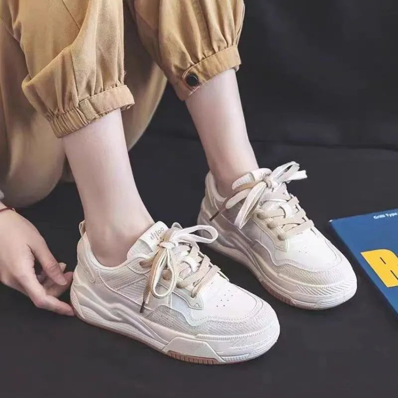 Pink and beige low top sneakers with rubber soles and height-increasing design