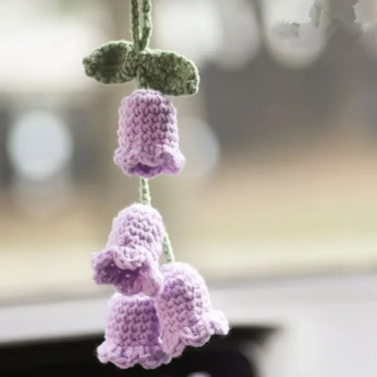 Green and white knitted wool car plant decoration basket with white hanging cord.