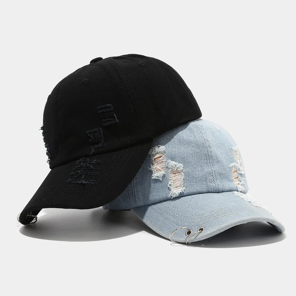 Men's adjustable denim peaked cap in black, shown from a side angle.