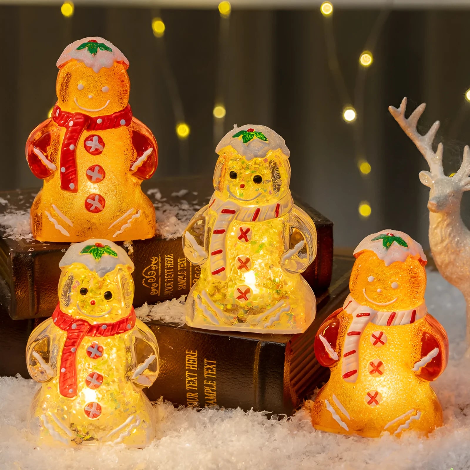 Set of four glowing plastic Christmas ornaments: gingerbread men and snowmen with red, white, and transparent scarves.