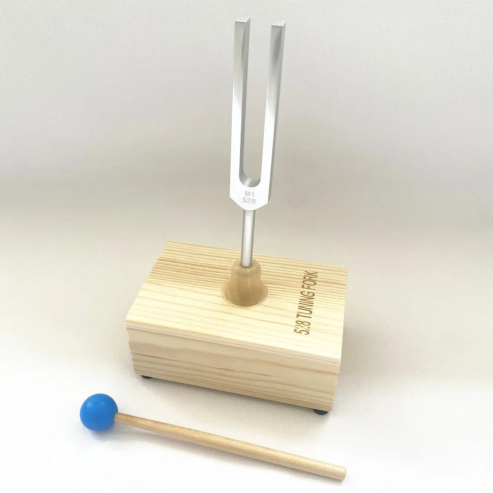 Aluminium alloy 432 Hz tuning fork with a matching speaker unit on a kraft paper box.