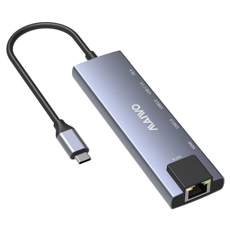 Steam Deck six-in-one aluminium docking station with HDMI, USB, and ethernet ports on a desk.