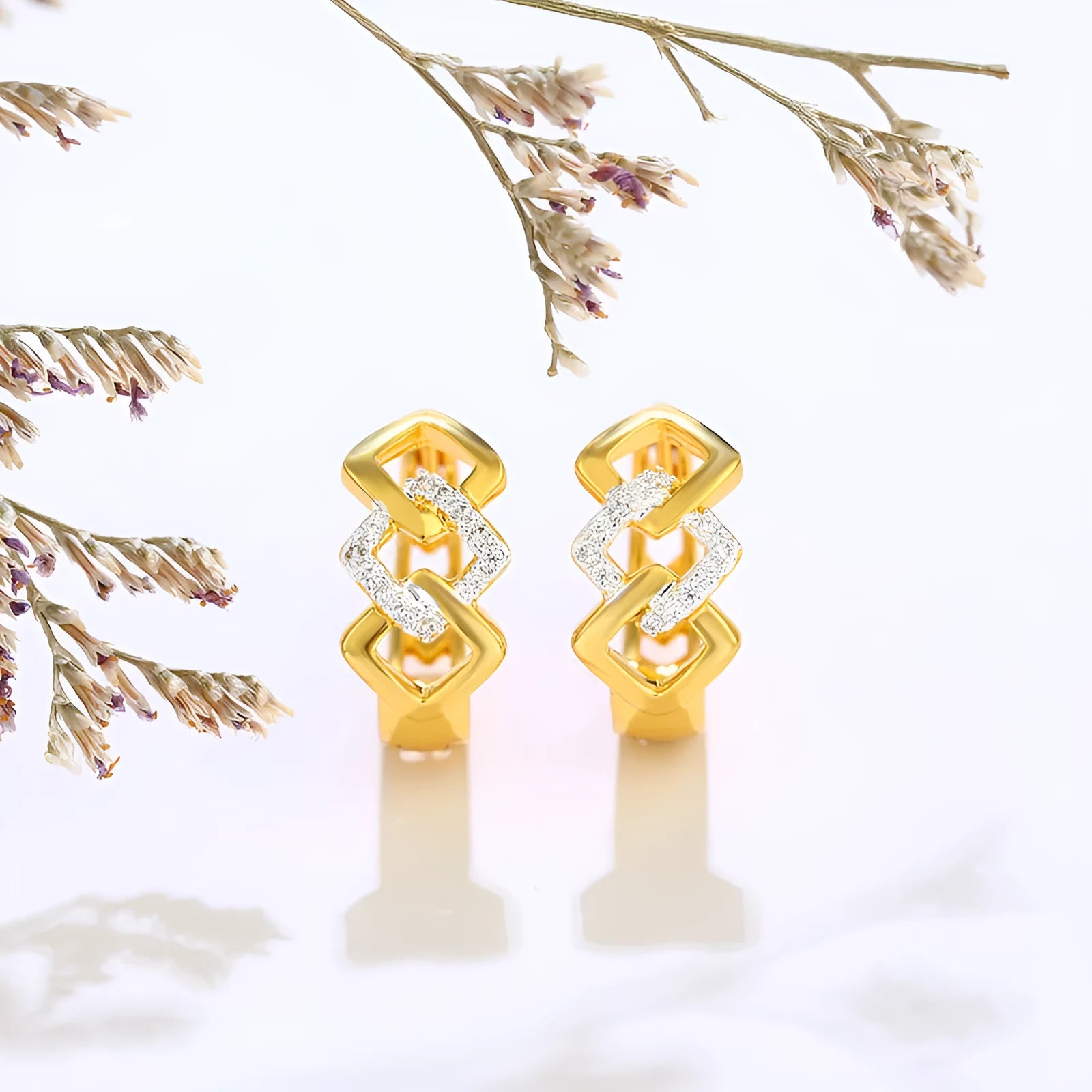 Gold geometric hollow-out earrings with electroplated finish and ear clip fastening