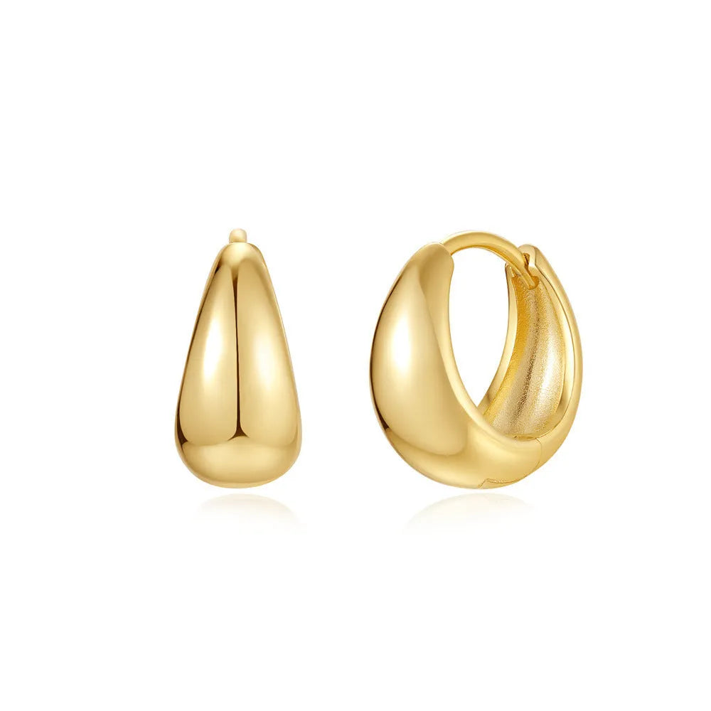 A pair of simple round geometric brass earclip earrings with a gold electroplated finish.